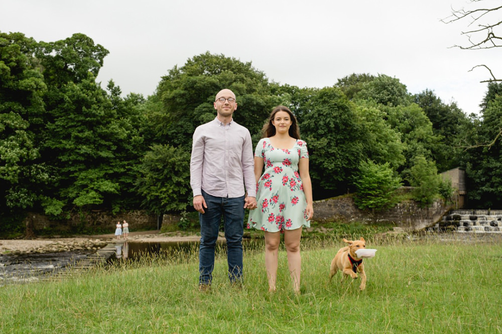 fun couple portrait with naughty dog as a pre wedding session in ilkely
