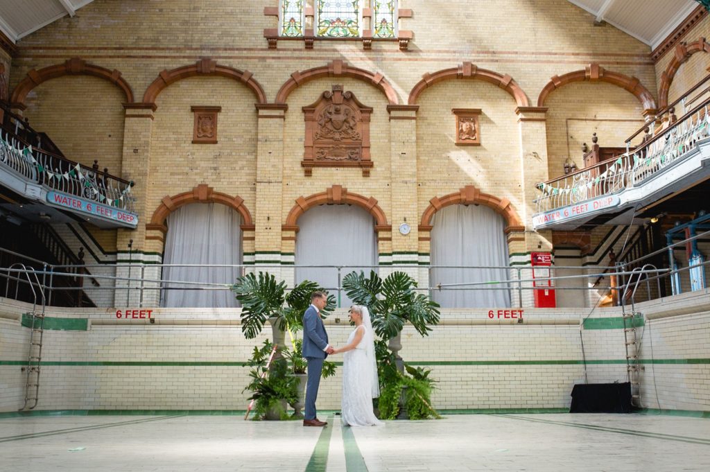 Portrait if couple in the main pool at Victoria Baths Swimming Pool wedding venue manchester