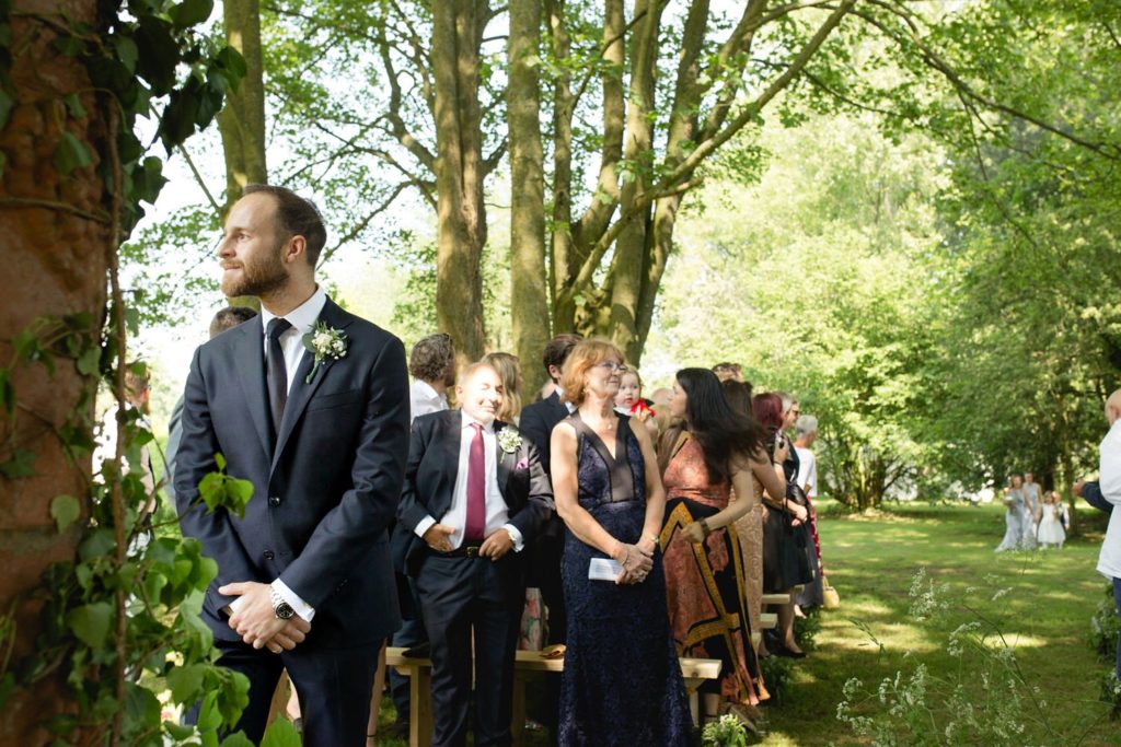 groom waiting for bride at top of aisle before their outdoor garden wedding kent
