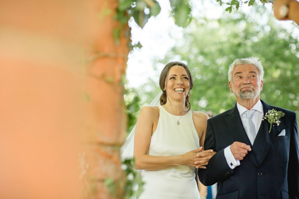 happy bride and dad about to get married in their back garden