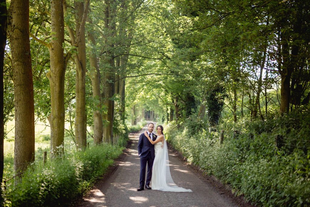 creative wedding portrait of couple in woodlands and country lane in kent