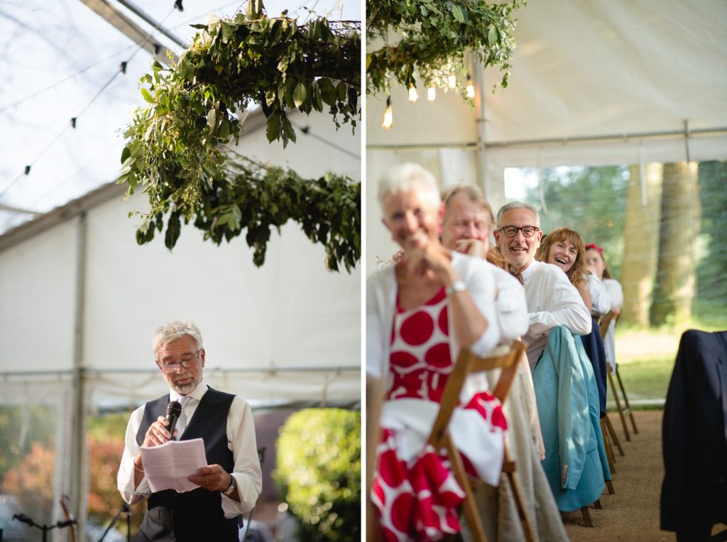 father of bride reading speech and guests looking on in back garden wedding