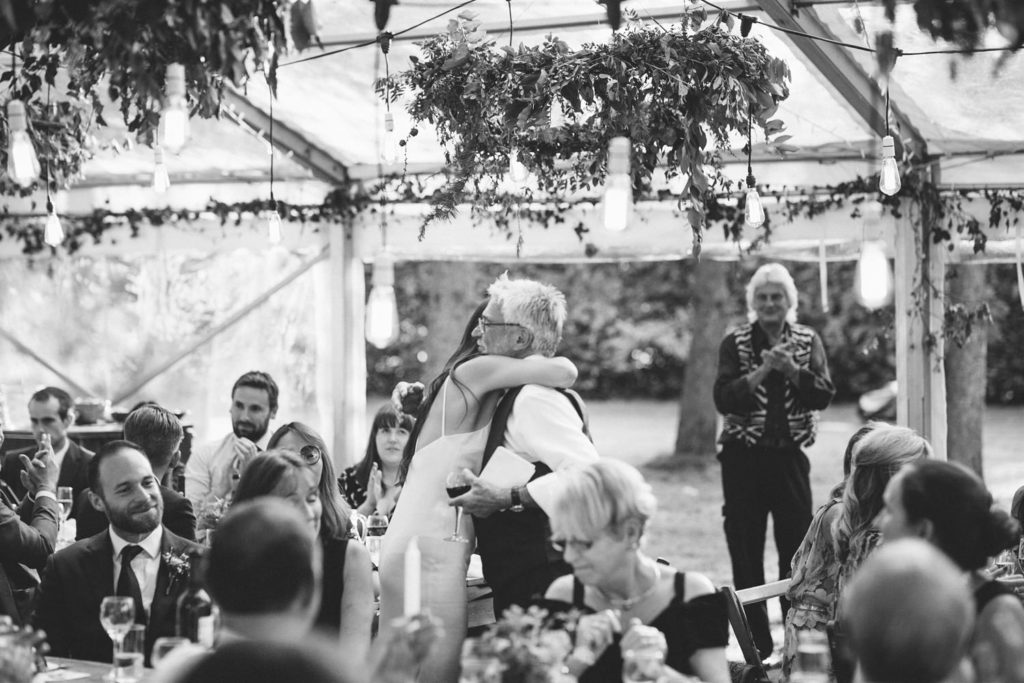 black and white documentary photo of bride and dad