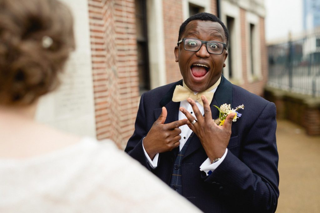 fun and quirky photo of groom outside of the tetley