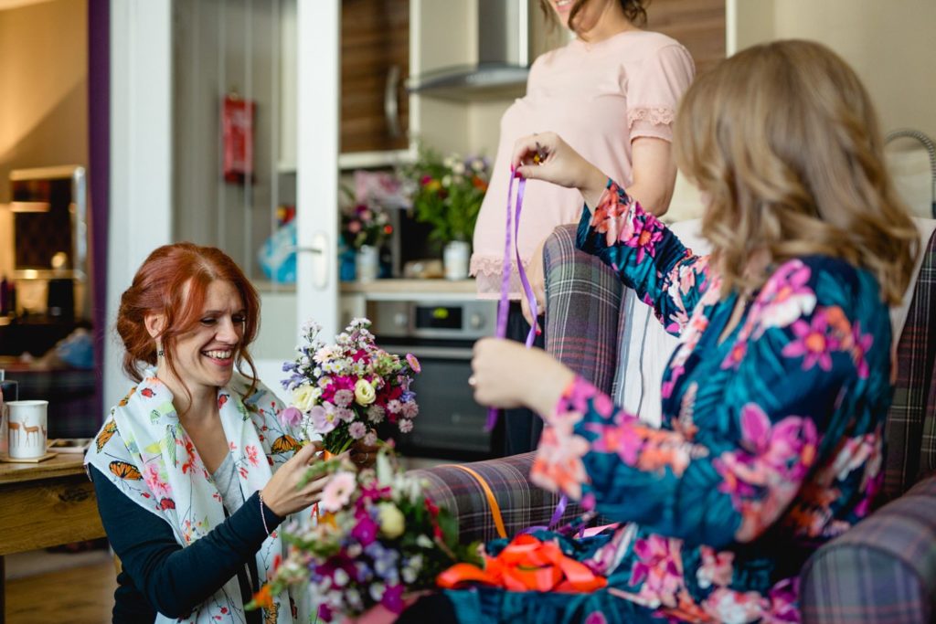 documentary photo of bride and bridesmaid getting ready in the peak district